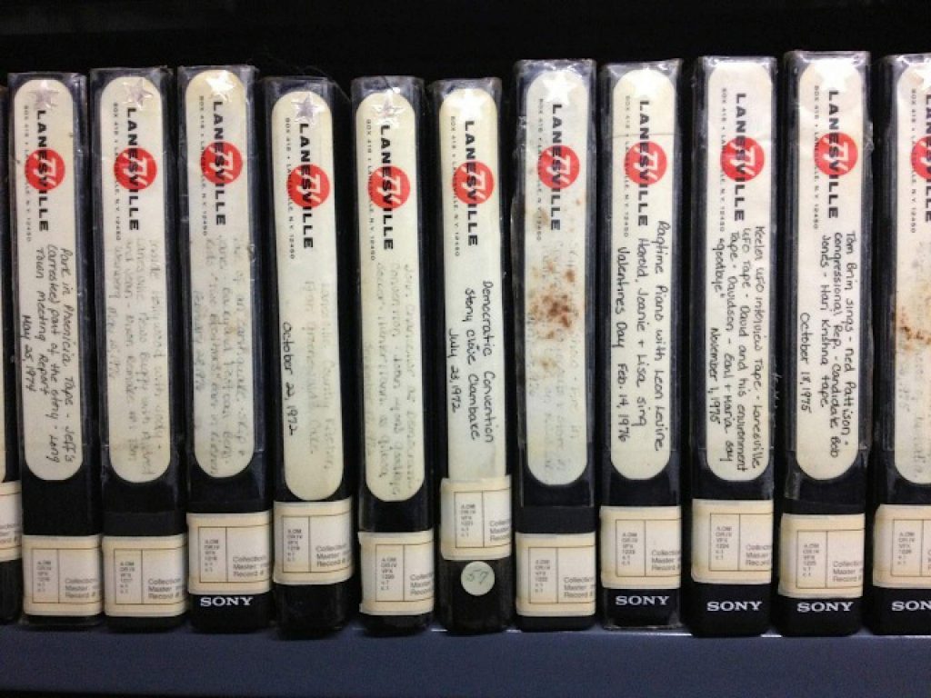 A shelf of labelled videotape cassettes