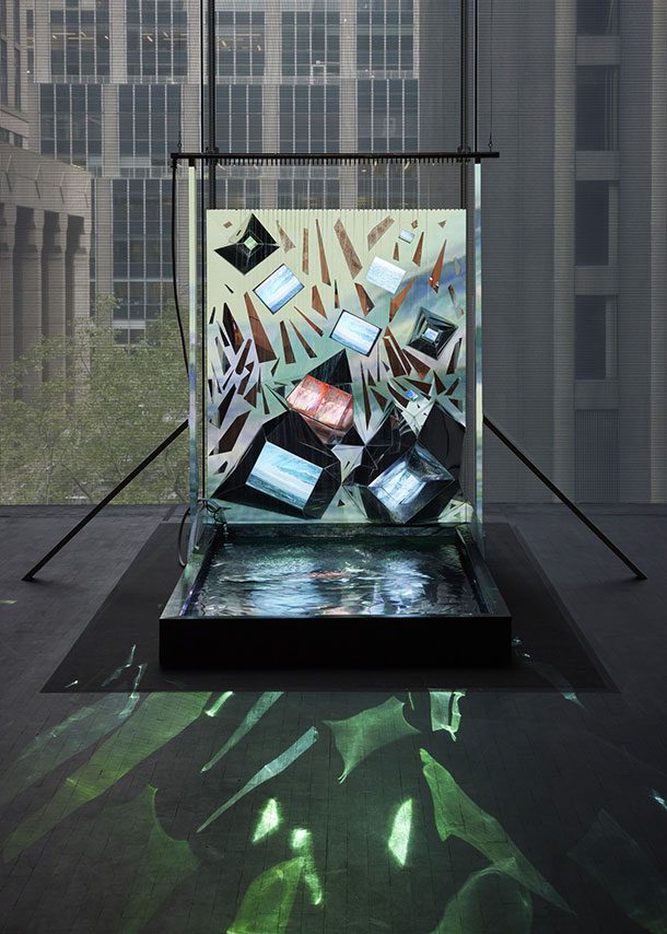 Shigeko Kubota installation at MoMA, 2021: video monitors set at angles in a panel above a pool of water